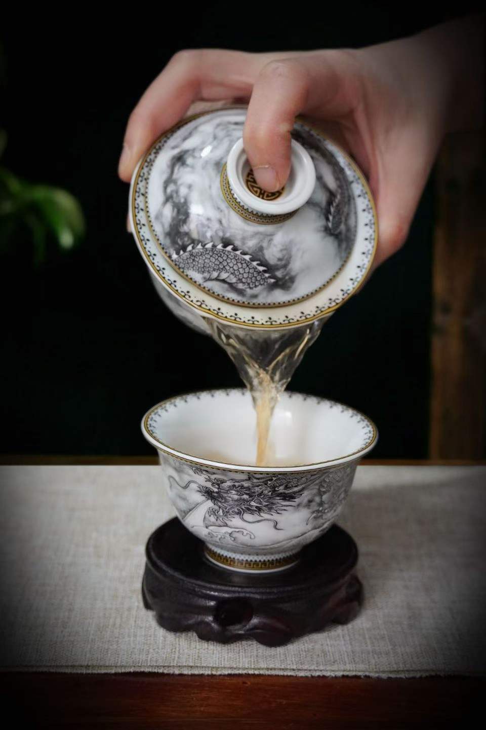 Ink Dragon gaiwan pouring tea